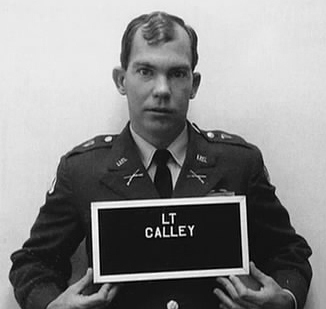 William Calley's mugshot. He is pictured in military garb with a nameplate. He has short hair and a blank expression.