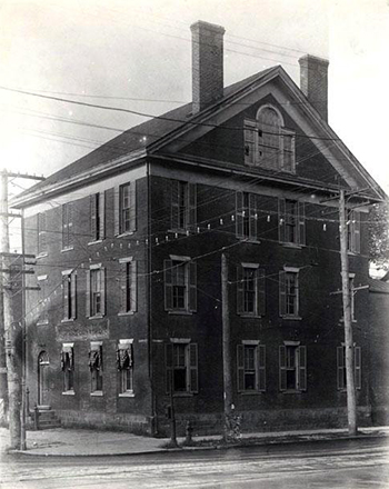 Fabius J. Haywood house in Raleigh. A large 3 story house with two chimneys and pitched roof. There are many windows on this brick building.