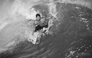 Surfer, Emerald Isle, NC, 2012. Image courtesy of Flickr user The Uprooted Photographer. 