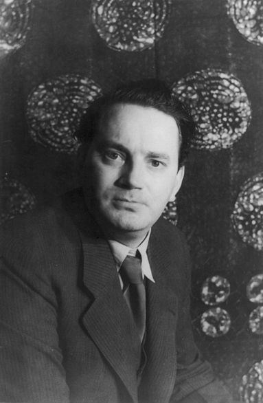 Thomas Wolfe. He is posing for the portrait with a suit and tie. He has styled hair and a stern expression.